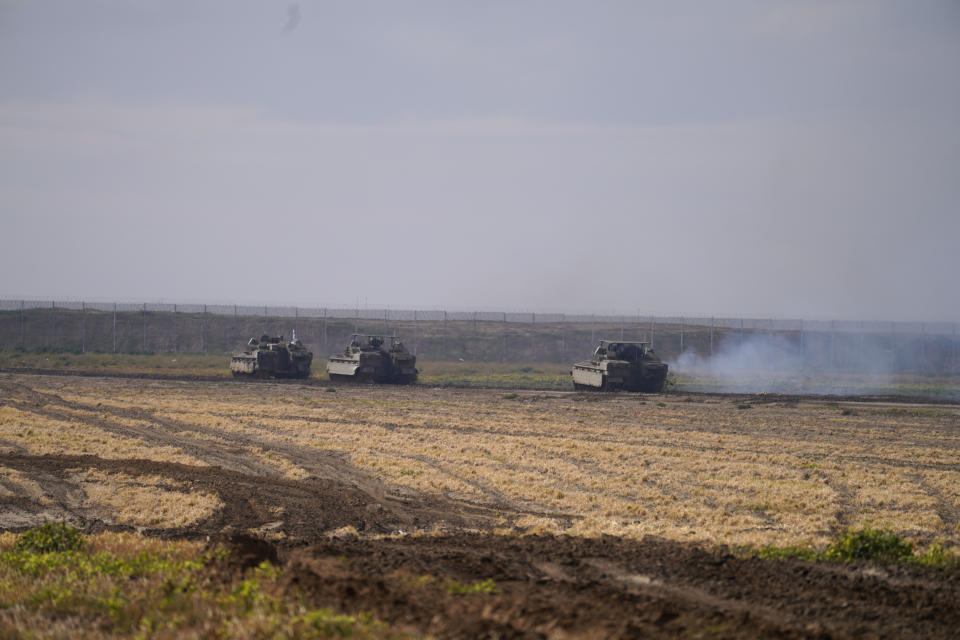 Israeli soldiers drive in their armored vehicles in southern Israel near the border with the Gaza Strip during ongoing ground operations, Friday, Feb. 2, 2024. (AP Photo/Tsafrir Abayov)
