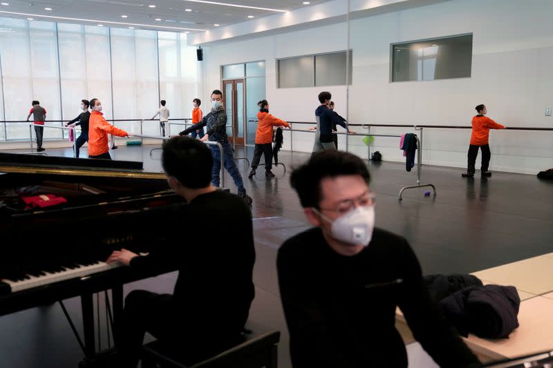 Shanghai Ballet dancers wearing masks practise in a dance studio in Shanghai
