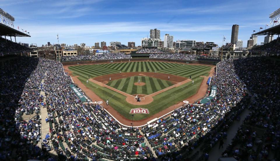 The Arizona Diamondbacks and Chicago Cubs begin a baseball game Wednesday, April 23, 2014, in Chicago. Wednesday was the 100th anniversary of the first game at the ballpark, between the Chicago Federals and the Kansas City Packers. (AP Photo/Charles Rex Arbogast)