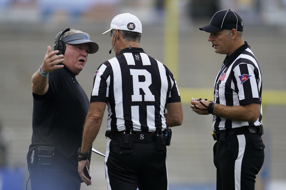 UCLA head coach Chip Kelly, left, talks with officials during the first half of an NCAA college football game against South Alabama in Pasadena, Calif., Saturday, Sept. 17, 2022. (AP Photo/Ashley Landis)