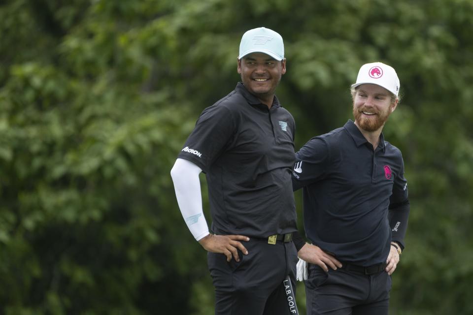 From left to right, Sebastián Muñoz, of Torque GC, and Kieran Vincent, of Legion XIII, smile on the seventh green during the final round of LIV Golf Nashville at The Grove, Sunday, June 23, 2024, in College Grove, Tenn. (Mike Stobe/LIV Golf via AP)