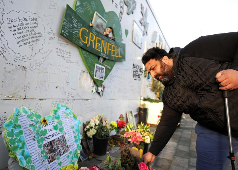 Dad-of-three Nabil Choucair lost six relatives in the fire, including his mum, sister, brother-in-law and three young nieces, pictured here laying flowers in tribute, December 2021. (Xinhua via Getty Images)