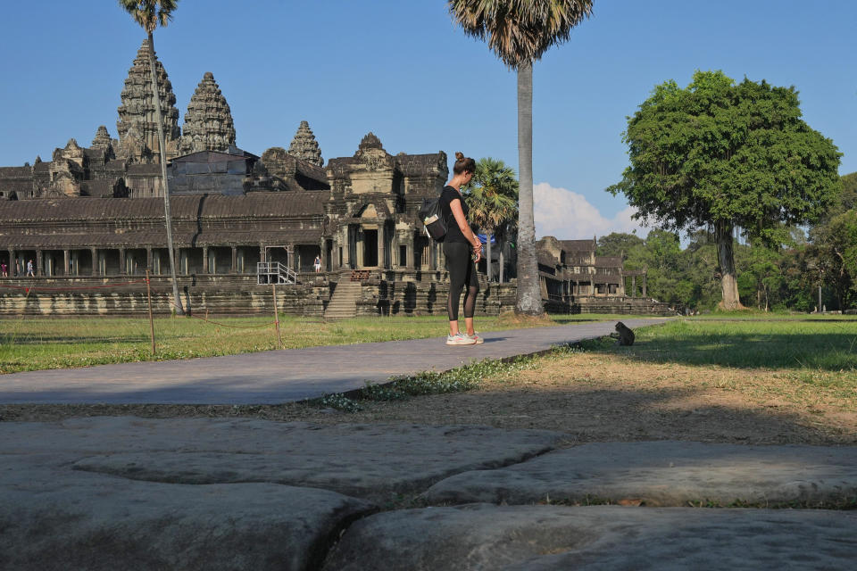 A monkey climbs a tree at Angkor Wat temple complex in Siem Reap province, Cambodia, Tuesday, April 2, 2024. Cambodian authorities are investigating the abuse of monkeys at the famous Angkor UNESCO World Heritage Site. Officials say some YouTubers are physically abusing the macaques to earn cash by generating more views. (AP Photo/Heng Sinith)