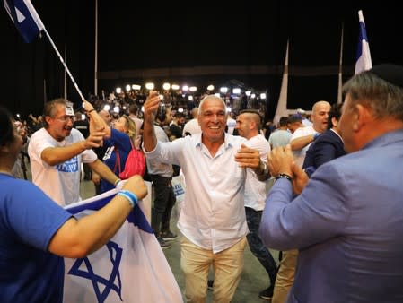 Supporters of Israeli Prime Minister Benjamin Netanyahu's Likud party react to exit polls in Israel's parliamentary election at the party headquarters in Tel Aviv