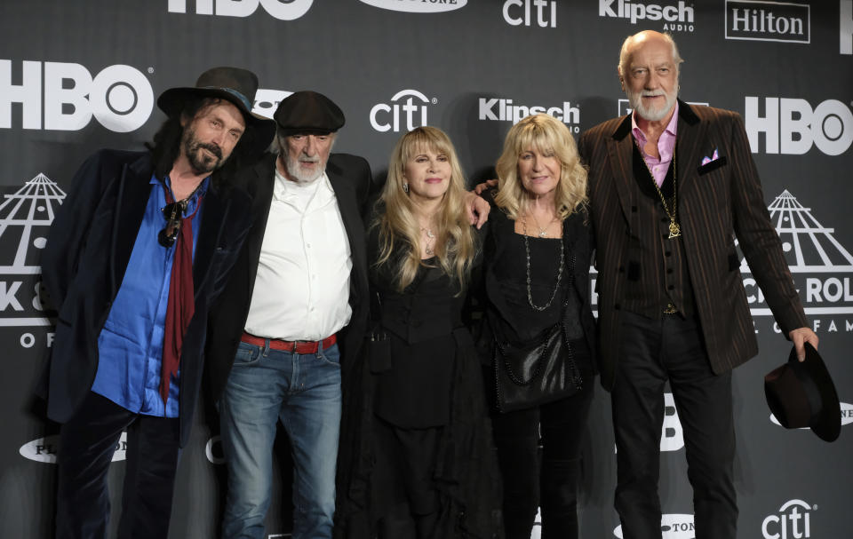 FILE - Members of Fleetwood Mac, from left, Mike Campbell, John McVie, Stevie Nicks, Christine McVie and Mick Fleetwood appear at the Rock & Roll Hall of Fame induction ceremony in New York on March 29, 2019. Christine McVie, the soulful British musician who sang lead on many of Fleetwood Mac’s biggest hits, has died at 79. The band announced her death on social media Wednesday. (Photo by Charles Sykes/Invision/AP, File)