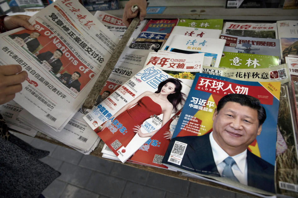 FILE - A magazine featuring Chinese President Xi Jinping with the headline "China becomes strong" is placed next to a magazine with popular Chinese actress Fan Bingbing at a news stand in Beijing, China, Saturday, Oct. 21, 2017. Among Chinese celebrities in the entertainment world, tangling with the authorities can be a career killer. For business leaders, it can mean a loss of status, market access and possible incarceration. With political dissidents, it often means disappearance into the vast security state, without access to family or legal recourse. (AP Photo/Ng Han Guan, File)