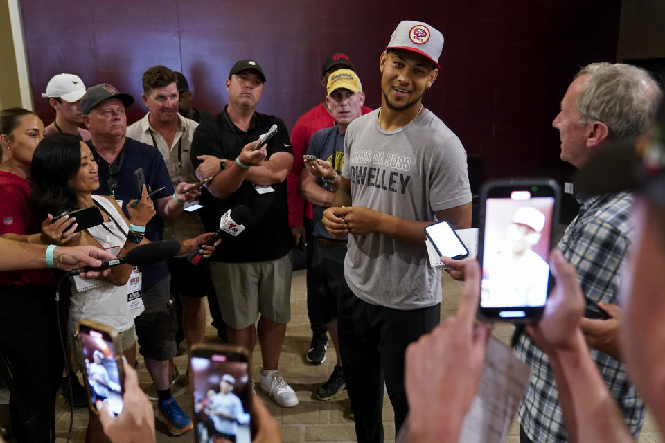 San Francisco 49ers' Trey Lance, center right, speaks to reporters after NFL football training camp Friday, Aug. 4, 2023, in Santa Clara, Calif. (AP Photo/Godofredo A. Vásquez)