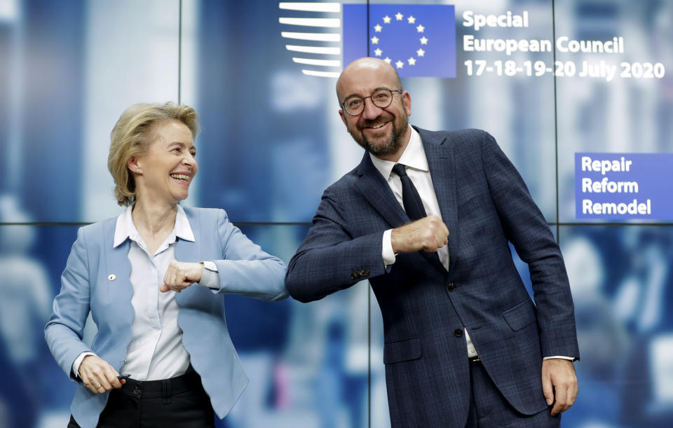 European Commission President Ursula von der Leyen, left, and European Council President Charles Michel bump elbows after addressing a media conference at an EU summit in Brussels, Tuesday, July 21, 2020. Weary European Union leaders finally clinched an unprecedented budget and coronavirus recovery fund early Tuesday, finding unity after four days and as many nights of fighting and wrangling over money and power in one of their longest summits ever. (Stephanie Lecocq, Pool Photo via AP)