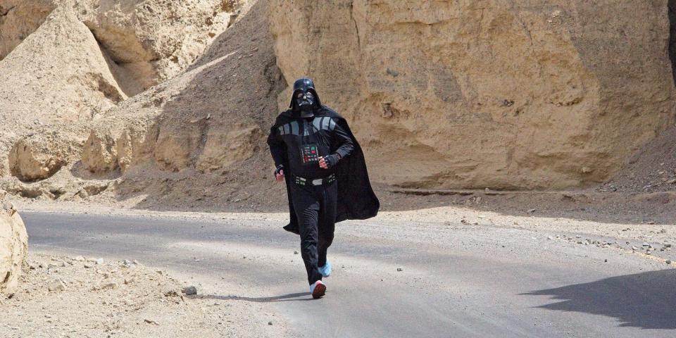 A man dressed in Darth Vader costume runs on a road in Death Valley, California, on its hottest day in 2022.