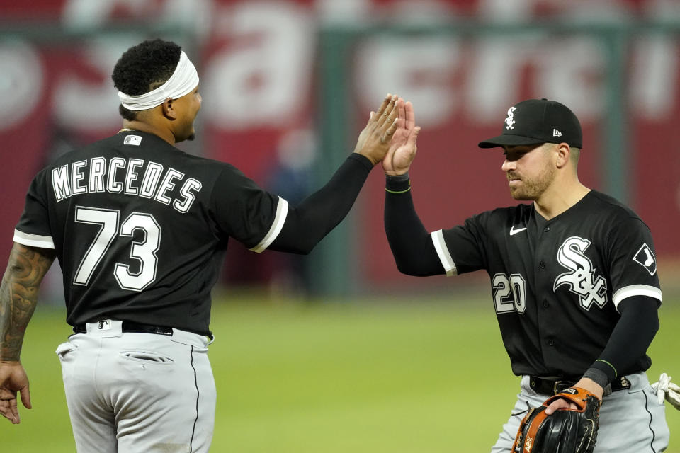 Chicago White Sox catcher Yermin Mercedes and second baseman Danny Mendick (20) celebrate after their baseball game against the Kansas City Royals Saturday, May 8, 2021, in Kansas City, Mo. The White Sox won 9-1. (AP Photo/Charlie Riedel)