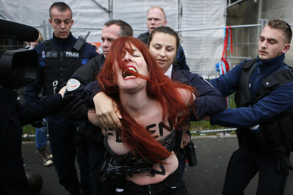 <p>A Femen activist is led away by French police in Hénin-Beaumont, northern France, May 7, 2017. Voters across France chose a new president in an unusually tense and important election that could decide Europe’s future, making a stark choice between pro-business progressive candidate Emmanuel Macron and far-right populist Marine Le Pen. (Francois Mori/AP) </p>