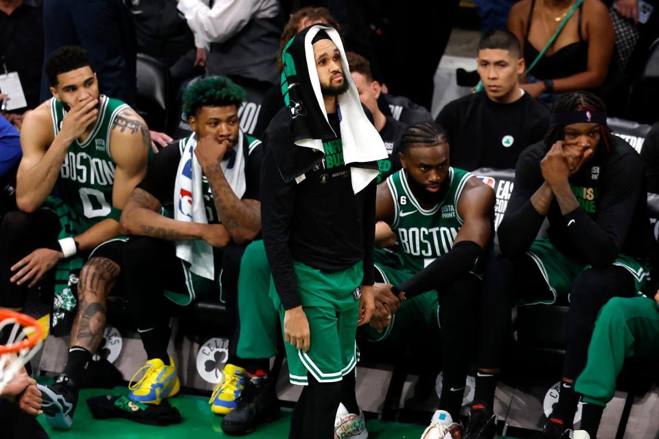 Derrick White and the Boston Celtics bench watches the final seconds of their Game 7 loss to the Miami Heat.