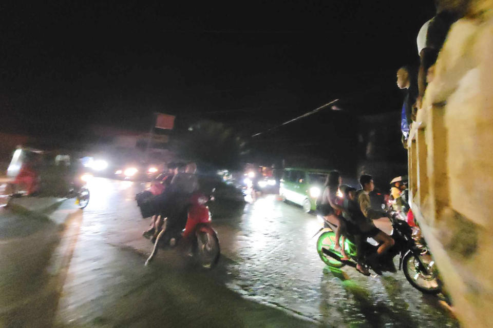In this photo released by the Local Government Unit of Hinatuan, villagers evacuate after an earthquake at Hinatuan town, Surigao del Sur province, southern Philippines, late Saturday, Dec. 2, 2023. (Local Government Unit of Hinatuanvia AP)