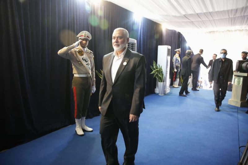 Palestinian Hamas chief ISMAIL HANIYEH (R) arrives at the swearing-in ceremony for the new Iranian president in Tehran. Iranian Supreme Leader Ayatollah Ali Khamenei has threatened "severe punishment" for Israel in retaliation for the assassination of Hamas' political leader Ismail Haniyeh in Tehran. "The criminal Zionist regime [Israel] has murdered our guest in our house," Khamenei was quoted as saying on his website. "There will be a severe punishment." Icana News Agency/ZUMA Press Wire/dpa