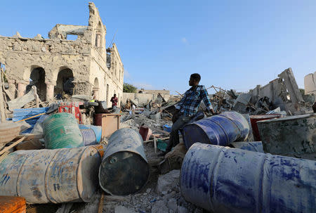 A resident stands within the debris at the scene after a suicide car explosion in front of Doorbin hotel in Mogadishu, Somalia February 24, 2018. REUTERS/Feisal Omar