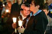 Women mourn during a vigil at a Walmart parking lot in Roseburg, Oregon, on October 2, 2015