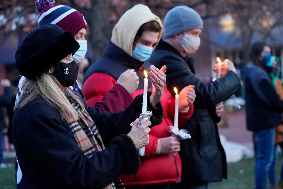 Mourners gather for a vigil for the victims of a mass shooting at a grocery store in Boulder, Colo.