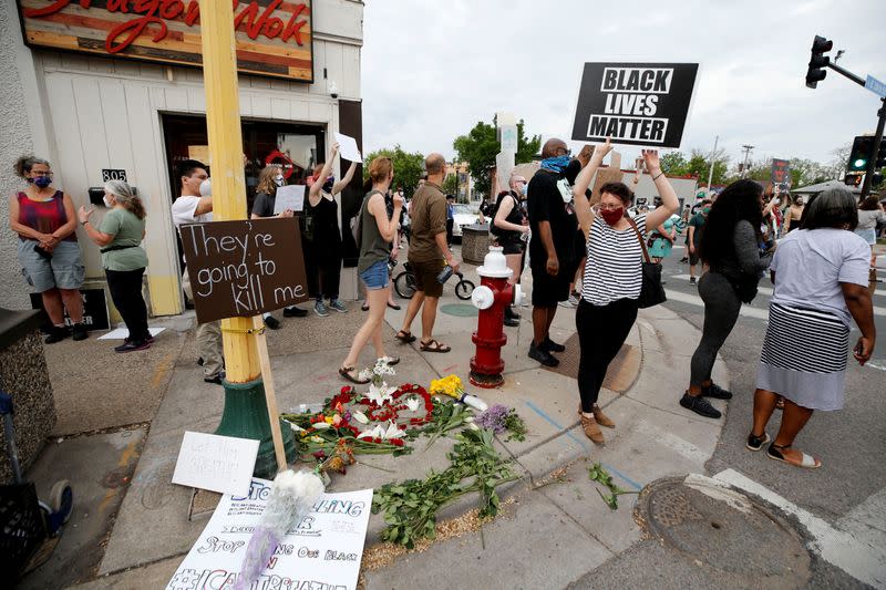 Protesters gather at the scene where Floyd was pinned down by a police officer in Minneapolis