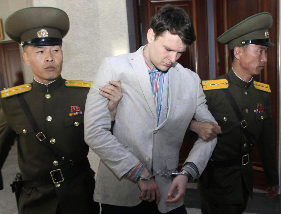 <p>U.S. student Otto Warmbier is escorted at the Supreme Court in Pyongyang, North Korea, March 16, 2016. (Photo: Jon Chol Jin/AP) </p>