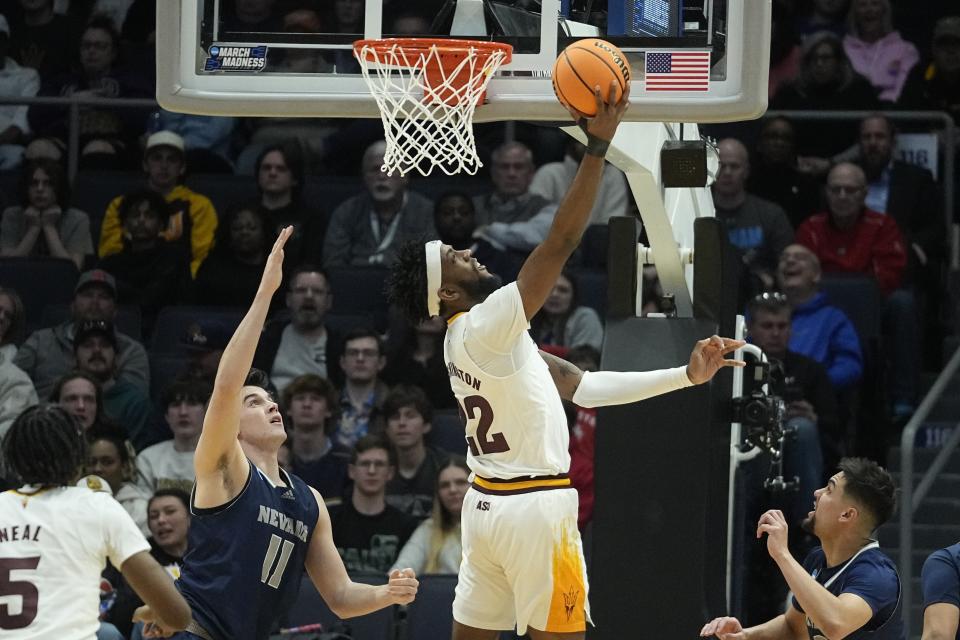 Arizona State's Warren Washington (22) puts up a shot against Nevada's Nick Davidson (11) during the first half of a First Four college basketball game in the NCAA men's basketball tournament, Wednesday, March 15, 2023, in Dayton, Ohio. (AP Photo/Darron Cummings)