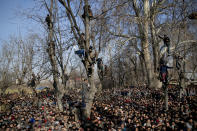 Kashmiri villagers watch the funeral of Zahoor Ahmed, a soldier turned rebel, in Pulwama south of Srinagar, Indian controlled Kashmir, Saturday, Dec. 15, 2018. At least seven civilians were killed and nearly two dozens injured when government forces fired at anti-India protesters in disputed Kashmir following a gunbattle that left three rebels and a soldier dead on Saturday, police and residents said. (AP Photo/ Dar Yasin)