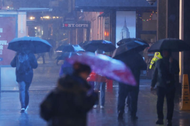 Pedestrians carry umbrellas as they walks through heavy rain in Times Square in New York City on Monday. Heavy rain and gusty winds battered New York City overnight, leaving thousands of residents without power. Photo by John Angelillo/UPI