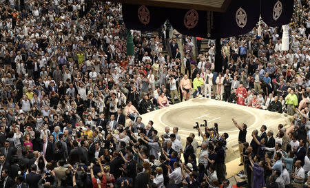 People take photos of U.S. President Donald Trump during the final day of the Summer Grand Sumo Tournament at Ryogoku Kokugikan in Tokyo, Japan May 26, 2019, in this photo taken by Kyodo. Mandatory credit Kyodo/via REUTERS