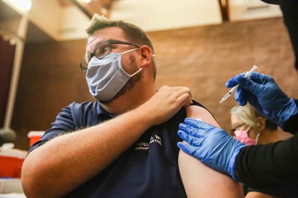 Clint Hampton receives a vaccine at a clinic offering COVID-19 vaccinations at the New Mexico Farm & Ranch Heritage Museum in Las Cruces on Tuesday, Oct. 19, 2021.