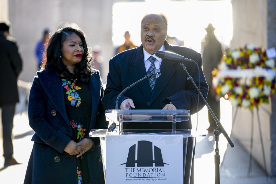 Martin Luther King III, center, the son of Martin Luther King Jr., accompanied by his wife Arndrea Waters King, both with the Drum Major Institute, speaks during a wreath-laying ceremony at the Martin Luther King Jr. Memorial on Martin Luther King Jr. Day in Washington, Monday, Jan. 16, 2023. (AP Photo/Andrew Harnik)