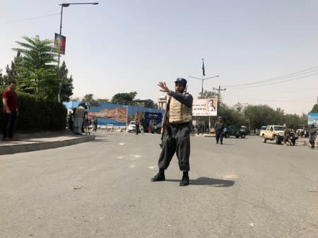 An Afghan policeman keeps watch near the site of a blast in Kabul, Afghanistan