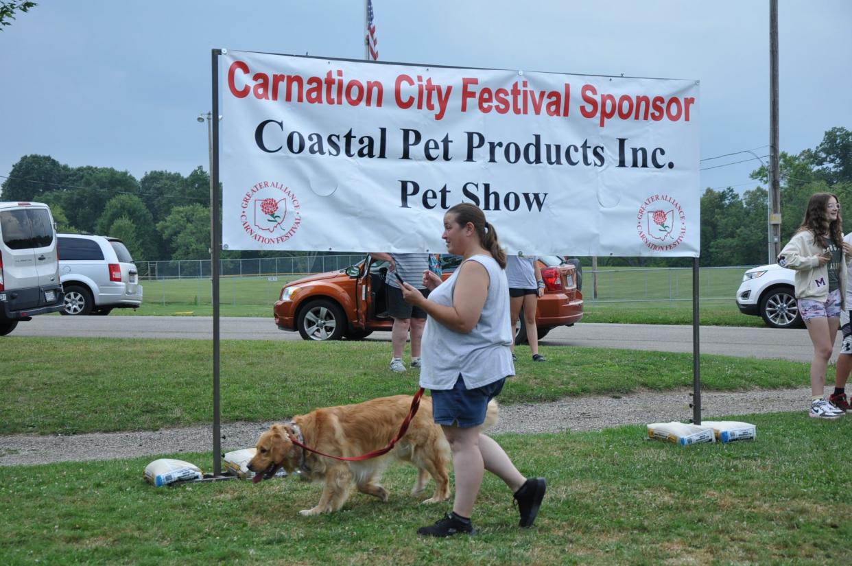 Linda Ryan of Alliance walks with her dog Boomer after Ryan's daughter Aubree showed him on stage at the Greater Alliance Carnation Festival Pet Show on Aug. 11, 2023.