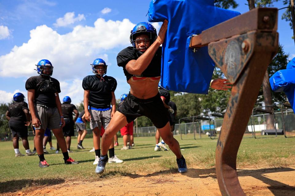 Trinity linebacker Cameron Anderson hits the tackling sled during football practice Wednesday, Aug. 9, 2023 at Trinity Christian Academy in Jacksonville, Fla. 