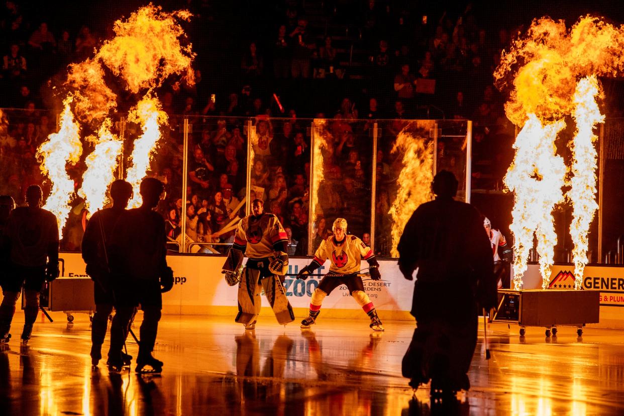 Coachella Valley Firebirds enter the ice in the season opener against Bakersfield Condors at Acrisure Arena in Palm Desert, Calif., on Friday, Oct. 13, 2023.