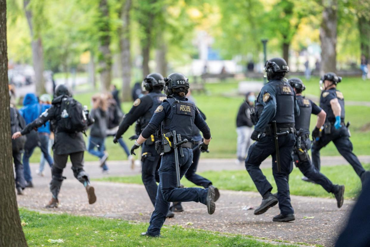 Portland Police chase protesters who re-occupied the Portland State University Library building after it had been cleared and several protesters detained earlier in the day, during the ongoing conflict between Israel and the Palestinian Islamist group Hamas, in Portland, Oregon, U.S., May 2, 2024 (REUTERS)