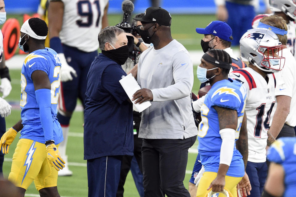 New England Patriots head coach Bill Belichick, center left, shakes hands with Los Angeles Chargers head coach Anthony Lynn at the end of an NFL football game Sunday, Dec. 6, 2020, in Inglewood, Calif. (AP Photo/Kelvin Kuo)
