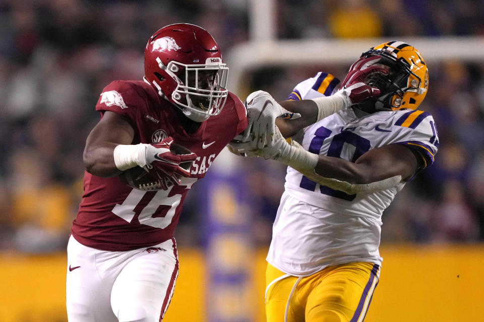 Arkansas Razorbacks wide receiver Treylon Burks (16) runs the ball against LSU Tigers linebacker Mike Jones Jr. (19) in the second half at Tiger Stadium.