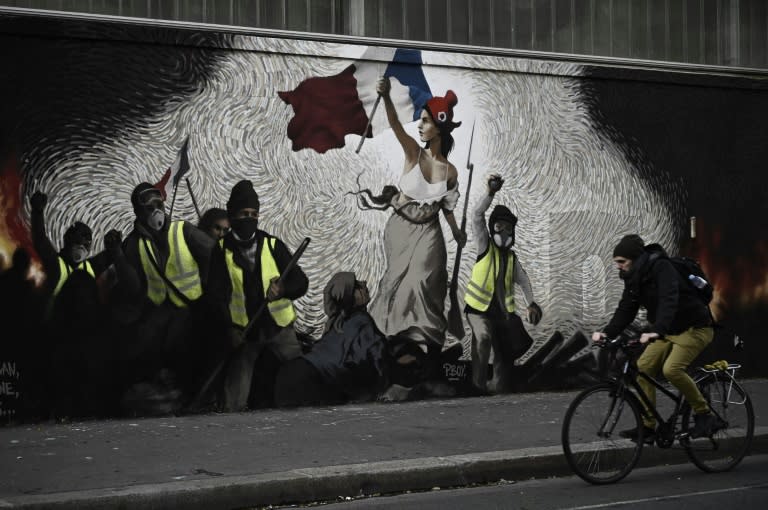 A mural by street artist PBOY depicts 'yellow vest' protesters inspired by a painting by Eugene Delacroix