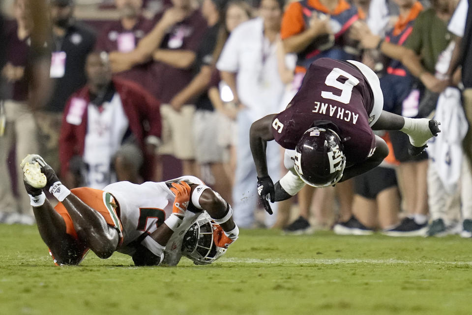 Texas A&M running back Devon Achane (6) is upended by Miami safety Kamren Kinchens (24) during the second quarter of an NCAA college football game Saturday, Sept. 17, 2022, in College Station, Texas. (AP Photo/Sam Craft)