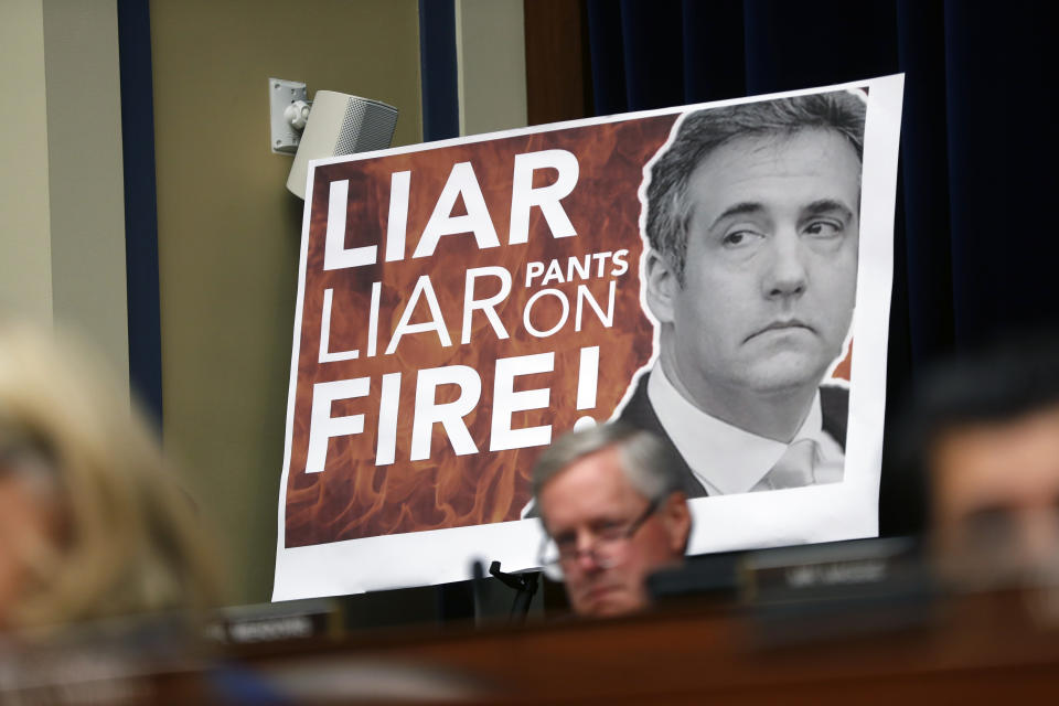 A poster on display during a hearing with Michael Cohen, President Donald Trump's former personal lawyer, before the House Oversight and Reform Committee on Capitol Hill in Washington, Wednesday, Feb. 27, 2019. (AP Photo/Pablo Martinez Monsivais)