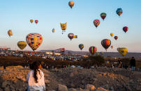 <p>A girl looks out at the hot-air balloon festival in Cajititlan, Mexico, May 07, 2017. (Hector Guerrero/AFP/Getty Images) </p>