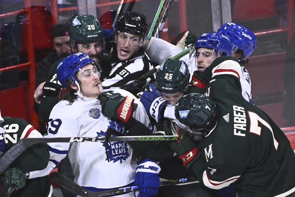 Toronto and Minnesota players in action during the NHL Global Series Sweden ice hockey match between Toronto Maple Leafs and Minnesota Wild at Avicii Arena in Stockholm, Sweden, Sunday Nov. 19, 2023. (Claudio Bresciani/TT via AP)