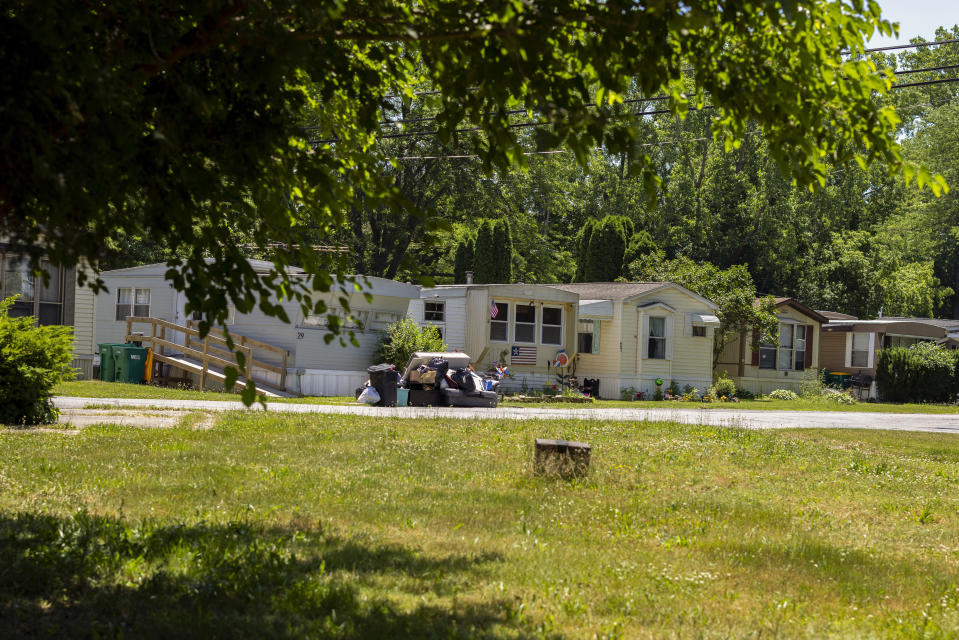 A line of manufactured homes in the Ridgeview Homes mobile home community in Lockport, N.Y., are seen June 23, 2022. For as long as anyone can remember, rent increases rarely happened at Ridgeview Homes, a once family-owned mobile home park in upstate New York. That changed in 2018 when corporate owners took over the 65-year-old park located amid farmland about 30 miles northeast of Buffalo. The plight of residents at Ridgeview is playing out nationwide as institutional investors, led by private equity firms and real estate trusts and sometimes funded by pension funds, swoop in to buy mobile home parks. (AP Photo/Lauren Petracca)