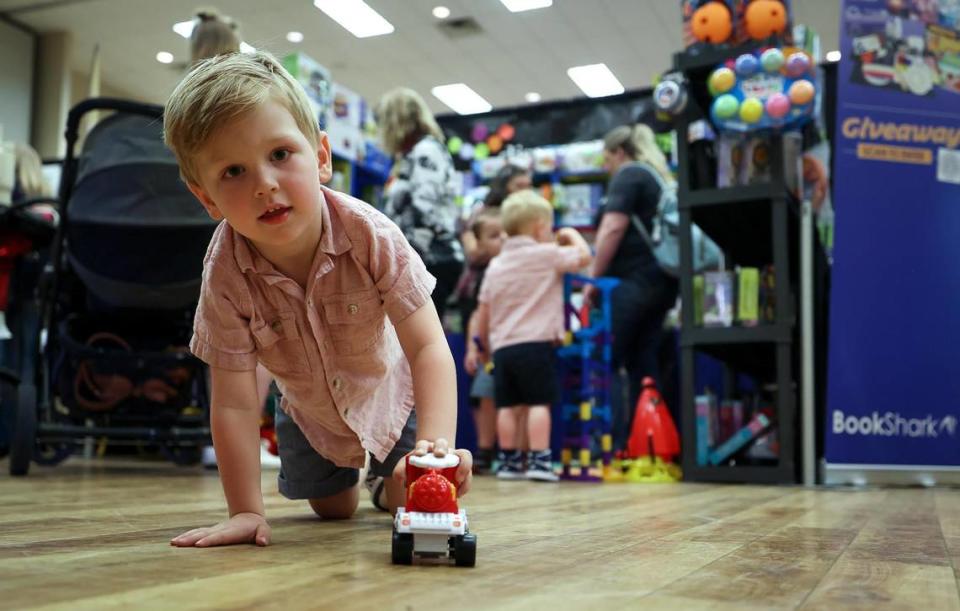 Rowen Going, 3, of Anna, Texas, plays with a educational toy while his mother talks to a vendor at the Texas Homeschool Expo at the Grapevine Convention Center on Friday, June 9, 2023, in Grapevine.