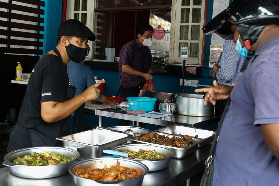 Customers are seen placing their orders at Quallys Nusantara Kitchen.