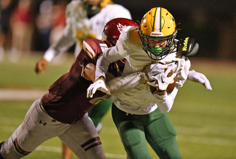 Episcopal Eagles Matthew Jenkins (15) brings down Yulee's Preston Matricardi (19) on a fourth quarter pass play for short yardage. Nassau County's Yulee Hornets traveled to the Episcopal School of Jacksonville to take on the Eagles in High School football Friday, October 20, 2023. Yulee dominated the matchup with a 33 to 0 victory over Episcopal.