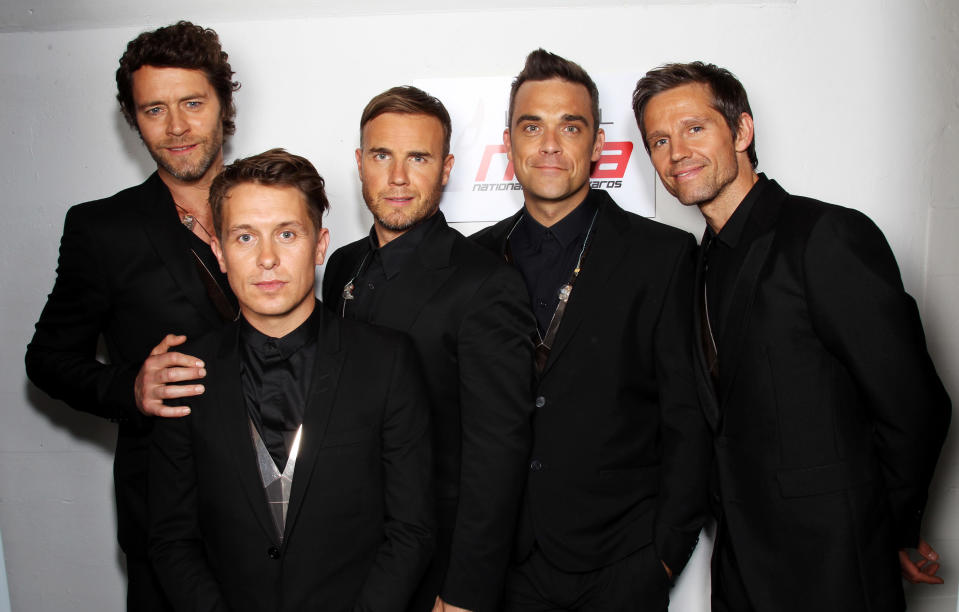 LONDON, ENGLAND - MAY 11: L-R Howard Donald, Mark Owen, Gary Barlow, Robbie Williams and Jason Orange of Take That pose backstage prior to performing at the National Movie Awards 2011 at Wembley arena on May 11, 2011 in London, England. (Photo by Dave J Hogan/Getty Images)
