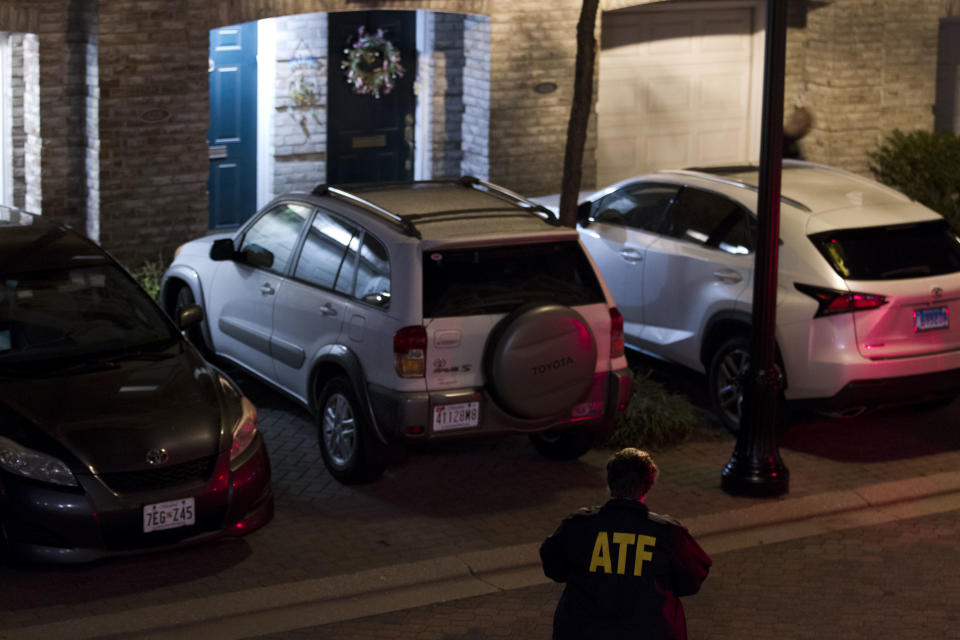 <p>An agent with the Bureau of Alcohol, Tobacco, Firearms and Explosives stands outside the family home, left door, in Baltimore, Sunday, Aug. 26, 2018, of the suspect in a mass shooting earlier in the day in Jacksonville, Fla. (Photo: Jose Luis Magana/AP) </p>