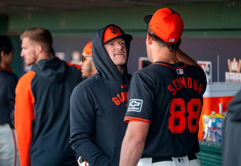 San Francisco Giants’ pitcher Logan Webb of Rocklin, center, talks with pitcher Carson Seymour in the dugout during a game against the Sacramento River Cats on Sunday.