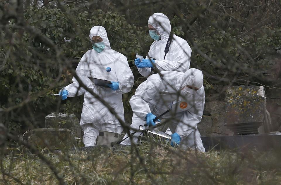 French gendarmes conduct their investigation near desecrated tombstones at the Sarre-Union Jewish cemetery, eastern France