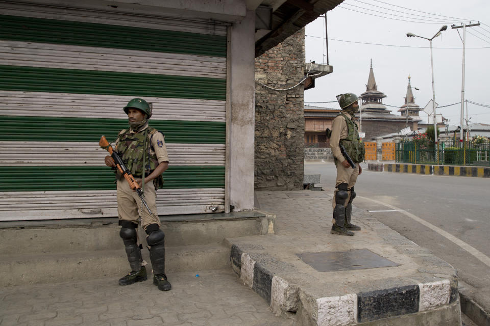 FILE- In this July 13, 2019 file photo, Indian paramilitary soldiers stand guard at a closed market area during a strike called by separatists in Srinagar, Indian controlled Kashmir. India's opposition leaders are angrily demanding Prime Minister Narendra Modi clarify his position in Parliament about President Donald Trump mediating India's long-running dispute with Pakistan over Kashmir. Indian External Affairs Minister S. Jaishankar said in Parliament on Tuesday that Modi made no such request to Trump as the U.S. president had claimed. (AP Photo/Dar Yasin, File)